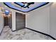 Modern bedroom features a tray ceiling with LED lighting and a ceiling fan with marble floors and closet at 6520 Simone Shores Cir, Apollo Beach, FL 33572