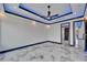 Modern bedroom features a tray ceiling with LED lighting and marble floors and closet at 6520 Simone Shores Cir, Apollo Beach, FL 33572