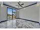 Modern bedroom boasts a ceiling fan, marble floors, and large sliding glass doors that look out to the pool at 6520 Simone Shores Cir, Apollo Beach, FL 33572
