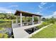 Covered boat dock with a boat lift on a sunny day at 6520 Simone Shores Cir, Apollo Beach, FL 33572