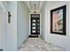 Welcoming entryway featuring a stylish front door, decorative lighting, and tiled flooring for a grand entrance at 6520 Simone Shores Cir, Apollo Beach, FL 33572