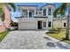 Stunning two-story home featuring a spacious driveway and lush landscaping, creating a grand entrance appeal at 6520 Simone Shores Cir, Apollo Beach, FL 33572