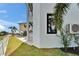 Exterior detail of the side of a modern home, showing a window and AC unit at 6520 Simone Shores Cir, Apollo Beach, FL 33572