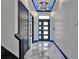 Elegant foyer boasts a modern chandelier, marble floors, and sleek, minimalist design with ambient lighting at 6520 Simone Shores Cir, Apollo Beach, FL 33572