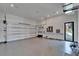 Spacious garage with epoxy floors, storage, and a fan at 6520 Simone Shores Cir, Apollo Beach, FL 33572