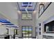 Bright great room with marble floors, high ceilings, modern lighting, and pool views from the sliding glass doors at 6520 Simone Shores Cir, Apollo Beach, FL 33572