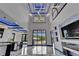 Spacious great room with marble floors, high ceilings, modern lighting, and sliding glass doors with pool views at 6520 Simone Shores Cir, Apollo Beach, FL 33572