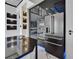 Modern kitchen boasts stainless appliances, island, unique backsplash and blue LED lighting at 6520 Simone Shores Cir, Apollo Beach, FL 33572