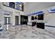 Modern kitchen boasts marble floors, two islands, stainless appliances, and unique blue LED lighting at 6520 Simone Shores Cir, Apollo Beach, FL 33572