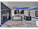 Modern kitchen boasts marble floors, island, stainless appliances, unique backsplash and blue LED lighting at 6520 Simone Shores Cir, Apollo Beach, FL 33572