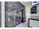 Modern kitchen boasts stainless appliances, island, unique backsplash and blue LED lighting at 6520 Simone Shores Cir, Apollo Beach, FL 33572
