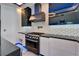 Modern kitchen with stainless oven and gas cooktop, unique backsplash and stainless hood vent at 6520 Simone Shores Cir, Apollo Beach, FL 33572