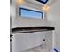 Functional laundry room featuring modern countertop and a window offering natural light at 6520 Simone Shores Cir, Apollo Beach, FL 33572