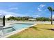 In-ground pool with view of white picket fence and a gazebo in the background at 6520 Simone Shores Cir, Apollo Beach, FL 33572