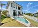 Beautiful, modern two-story home featuring a pool and a well-manicured lawn at 6520 Simone Shores Cir, Apollo Beach, FL 33572