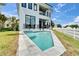 Beautiful, modern two-story home featuring a pool and a well-manicured lawn at 6520 Simone Shores Cir, Apollo Beach, FL 33572