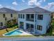 Beautiful home showcasing a view from the backyard with a pool, patio and two story exterior at 6520 Simone Shores Cir, Apollo Beach, FL 33572