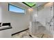 Bright bathroom featuring a glass shower, vanity and marble tile, under modern lighting at 6526 Simone Shores Cir, Apollo Beach, FL 33572