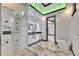 Stunning bathroom featuring a glass shower, sleek fixtures, marble tiling, and modern design at 6526 Simone Shores Cir, Apollo Beach, FL 33572