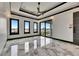 Spacious bedroom featuring stylish tray ceiling and luxurious marble floors at 6526 Simone Shores Cir, Apollo Beach, FL 33572
