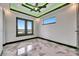 Spacious bedroom featuring sleek ceiling design, fan and luxurious marble floors at 6526 Simone Shores Cir, Apollo Beach, FL 33572