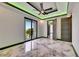 Bright bedroom featuring marble flooring, a ceiling fan, balcony access, and modern gray doors at 6526 Simone Shores Cir, Apollo Beach, FL 33572