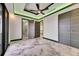 Light-filled bedroom with marble floors, fan, modern doors, and en-suite bathroom and closet entries at 6526 Simone Shores Cir, Apollo Beach, FL 33572