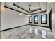 Spacious bedroom featuring stylish tray ceiling and luxurious marble floors at 6526 Simone Shores Cir, Apollo Beach, FL 33572