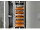 This well-organized closet offers space-saving features with sliding shelves and ambient lighting at 6526 Simone Shores Cir, Apollo Beach, FL 33572