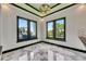 Bright dining area with large windows that offer views of the lush, tropical backyard at 6526 Simone Shores Cir, Apollo Beach, FL 33572