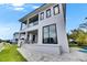 The exterior features a covered patio that looks out onto a serene lawn and a pool at 6526 Simone Shores Cir, Apollo Beach, FL 33572