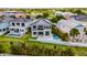 Modern two-story home with gray roof, fenced yard, and a swimming pool at 6526 Simone Shores Cir, Apollo Beach, FL 33572