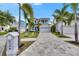 Beautiful two-story home with lush tropical landscaping and a long paved driveway at 6526 Simone Shores Cir, Apollo Beach, FL 33572