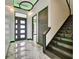 Elegant foyer features modern lighting, sleek doors, and marble flooring at 6526 Simone Shores Cir, Apollo Beach, FL 33572