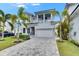 Stylish two-story home with a three-car garage, paver driveway and manicured landscaping at 6526 Simone Shores Cir, Apollo Beach, FL 33572