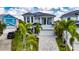 Charming two-story home featuring a manicured lawn, paver driveway, and modern architecture at 6526 Simone Shores Cir, Apollo Beach, FL 33572
