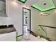 Hallway with modern lighting and staircase, adjacent to stylish bar and beverage center at 6526 Simone Shores Cir, Apollo Beach, FL 33572