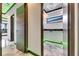 Hallway with modern doors, marble floors, and recessed lighting, leading to a laundry room at 6526 Simone Shores Cir, Apollo Beach, FL 33572