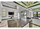 Spacious kitchen with a large center island, modern lighting, and seamless indoor-outdoor living at 6526 Simone Shores Cir, Apollo Beach, FL 33572