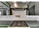 Modern kitchen features stainless steel range hood and designer backsplash at 6526 Simone Shores Cir, Apollo Beach, FL 33572