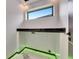 Modern laundry room featuring a window, counter, marble floors, and sleek design with black countertops at 6526 Simone Shores Cir, Apollo Beach, FL 33572