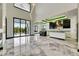 Open living space with high ceilings, marble floors, and expansive windows providing ample natural light at 6526 Simone Shores Cir, Apollo Beach, FL 33572