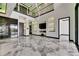 Open-concept living room featuring high ceilings, marble flooring, and a modern entertainment center at 6526 Simone Shores Cir, Apollo Beach, FL 33572