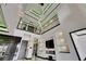 Stunning living room with soaring ceilings, custom lighting, and a modern staircase at 6526 Simone Shores Cir, Apollo Beach, FL 33572