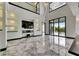 Spacious living room with tall ceilings, custom shelving, and large sliding glass doors to the patio at 6526 Simone Shores Cir, Apollo Beach, FL 33572