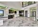 Spacious living area with open concept, modern kitchen, marble floors, and high ceilings at 6526 Simone Shores Cir, Apollo Beach, FL 33572