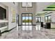 This spacious living room boasts soaring ceilings, an open layout, and sliding glass doors to the outside at 6526 Simone Shores Cir, Apollo Beach, FL 33572