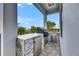 An elegant outdoor kitchen with a built-in grill and marble countertops sits on the patio at 6526 Simone Shores Cir, Apollo Beach, FL 33572
