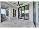 The outdoor patio has ample sunlight and a ceiling fan for relaxing on a hot day at 6526 Simone Shores Cir, Apollo Beach, FL 33572