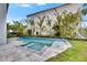 Backyard showcasing a modern pool and spa, surrounded by well-maintained landscaping at 6526 Simone Shores Cir, Apollo Beach, FL 33572